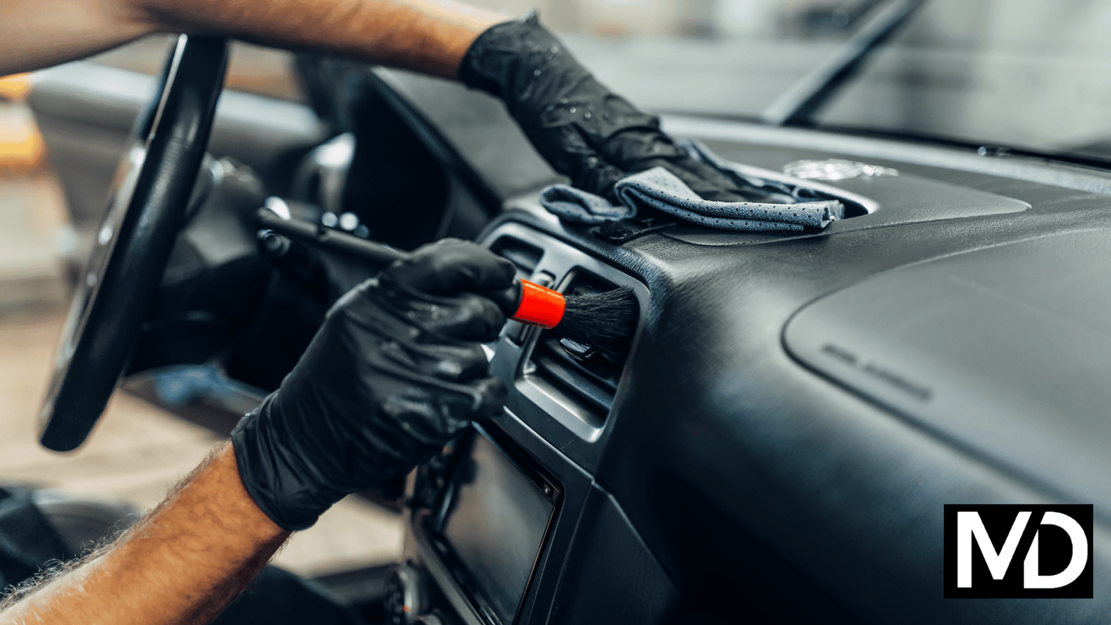 a person cleaning a car dashboard