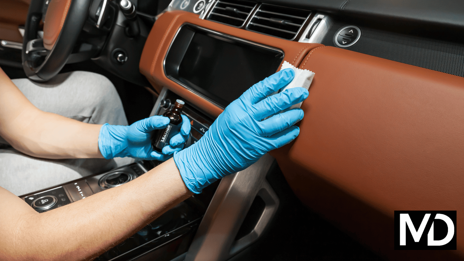 a person cleaning a car dashboard